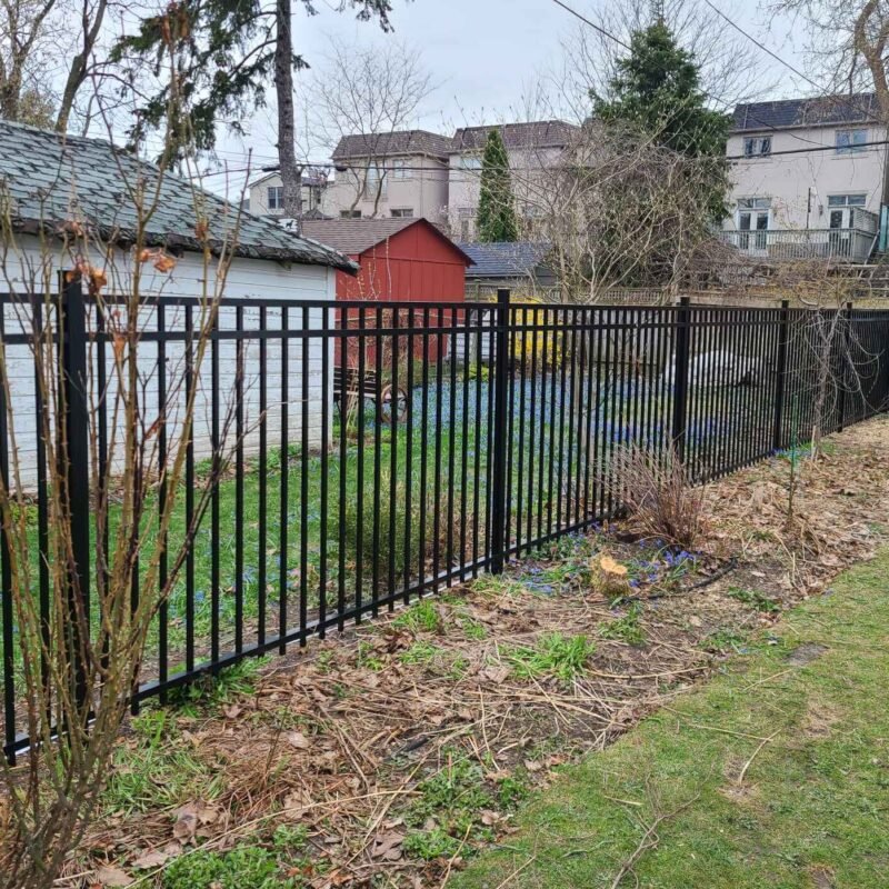 Black aluminum picket fence installed between neighbouring properties